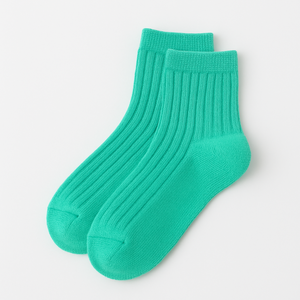 Pair of turquoise socks on a light gray background
